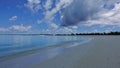 The beach line curves beautifully. Footprints in the sand. Royalty Free Stock Photo