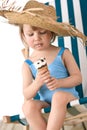 Beach - Little girl on deck-chair with ice-cream Royalty Free Stock Photo