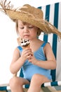 Beach - Little girl on deckchair with ice-cream Royalty Free Stock Photo