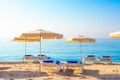 Beach in Lloret de Mar, Spain. Umbrellas and deckchairs on sandy beach