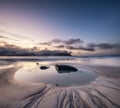 Beach on the Lofoten islands, Norway. Mountains, beach and clouds during sunset. Evening time. Winter landscape near the ocean.