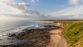 a beach with a long pathway going down to the ocean Royalty Free Stock Photo