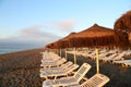 Beach lounge chair and beach umbrella at lonely sandy beach Royalty Free Stock Photo