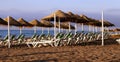 Beach lounge chair and beach umbrella at lonely sandy beach Royalty Free Stock Photo