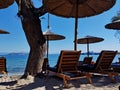 beach lounge chairs with parasols