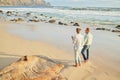 Beach, love and a senior couple walking on the sand by the ocean or sea for romance or dating at sunset. Nature, summer Royalty Free Stock Photo