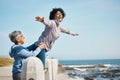 Beach, love and senior mother with woman doing airplane gesture playing, crazy and funny with parent for outdoor Royalty Free Stock Photo