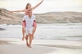Beach, love and summer couple walking on sand together for relaxing date with piggy back. Young, happy and playful Royalty Free Stock Photo