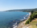 Beach lovers facing the Pacific Ocean from the fort of Niebla village. Estuary and mouth of the Valdivia River. Valdivia, Los Rios