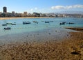 Beach at low tide, boats and city