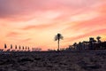 Beach mackenzie in the Larnaca city. Sea view, umbrellas and sunbeds on sunset. Makenzy, Cyprus Royalty Free Stock Photo