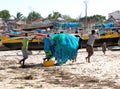 Beach with Malagasy canoes and fishermen with fishing nets, Madagascar