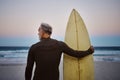 Beach, man and surfboard with back view for morning cardio fitness and tranquil swim in nature. Senior surfer waiting Royalty Free Stock Photo