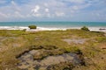 Beach with natural pool on coral reef and blue sea Royalty Free Stock Photo