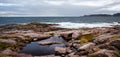 Beach on the northern ocean is made of stones covered with colorful moss. Teriberka, Barents Sea, Murmansk region, Kola Peninsula Royalty Free Stock Photo