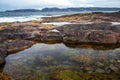 Beach on the northern ocean is made of stones covered with colorful moss. Teriberka, Barents Sea, Murmansk region, Kola Peninsula Royalty Free Stock Photo