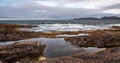 Beach on the northern ocean is made of stones covered with colorful moss. Teriberka, Barents Sea, Murmansk region, Kola Peninsula Royalty Free Stock Photo