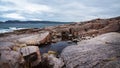 Beach on the northern ocean is made of stones covered with colorful moss. Teriberka, Barents Sea, Murmansk region, Kola Peninsula Royalty Free Stock Photo