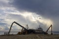 A barge pouring sand for beach nourishment in Terengganu, Malaysia