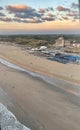 the beach and ocean are lit up during sunset as seen from a plane window Royalty Free Stock Photo