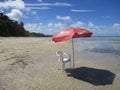 Beach for one under an exclusive red umbrella with a privileged view to the beach at Morere, Bahia State, Brazil