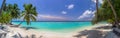 Beach panorama at Maldives with blue sky, palm trees and turquoise water