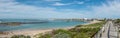 Beach panorama in Struisbaai with the boardwalk, boats and harbor