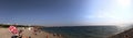 Beach panoramic view of the Mediterranean Sea in Turkey. City Beach of Antalya. Tourists are resting on the seashore