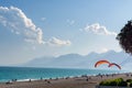 Beach on the beach with paragliders on the background of mountains Royalty Free Stock Photo