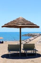 Beach with parasols made with bamboo and straw in the resort Royalty Free Stock Photo