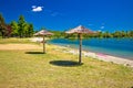 Beach and parasols on Soderica lake Royalty Free Stock Photo