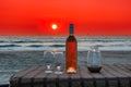 Beach party in cafe with bottle of rose wine and glasses at sunset, GOA, India Royalty Free Stock Photo