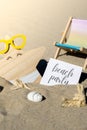 BEACH PARTY text on paper greeting card on background of beach chair lounge starfish summer vacation decor. Sandy beach