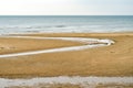 Beach patterns and small rivers on the beach formed by the low tide of the sea Royalty Free Stock Photo