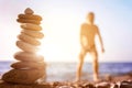 Beach pebble stones pyramid on sunset sea shore Royalty Free Stock Photo