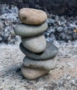 beach pebbles balanced in an artistic way on a sandy rock Royalty Free Stock Photo