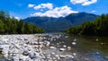 The beach with pebbles and stones on the shore of the lake. Royalty Free Stock Photo