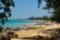 beach with people and a lighthouse Royalty Free Stock Photo