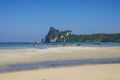 Beach of Phi Phi island in low tide with bay and longboat on background, Krabi province, Thailand