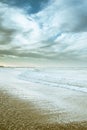 Beach photography - blue ocean waves, sand, overcast sky Royalty Free Stock Photo