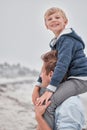 Beach, portrait of dad and child on shoulders with smile on family holiday or cloudy ocean walk in Australia. Travel