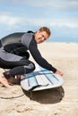 Beach, portrait of man and surfboard for exercise, fitness and body health outdoor in summer. Surfer, wetsuit and person