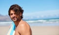 Beach portrait, surf and sports man on holiday, vacation or Spain getaway for nature, freedom or natural outdoor