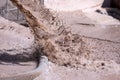 Beach reconstruction in progress. Solid stream of water with large amount of sand splashes onto a beach