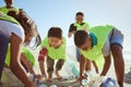 Beach, recycle and group of children cleaning the environment for volunteer, charity or ngo support, help and teamwork Royalty Free Stock Photo