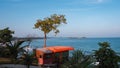 A beach with a red house on a cliff overlooking the ocean Royalty Free Stock Photo