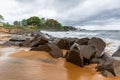 Beach with red sand and red rocks with a dramatic sky in Congo T