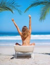 Beach, relax and back view of woman on chair on vacation, holiday or summer trip. Freedom, peace or young female in Royalty Free Stock Photo