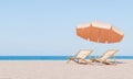 Beach Relaxation Scene with Sun Loungers and Umbrella