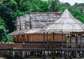 Beach resort with nipa hut cottages and forest as background Royalty Free Stock Photo